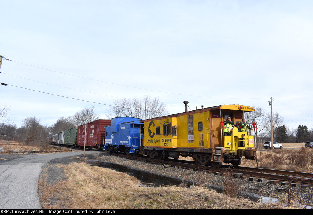 The two cabooses on the rear of the train as it crosses Rockafellow Ln Grade Crossing